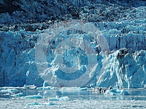 Immense glacier calving into a smaller mass of ice