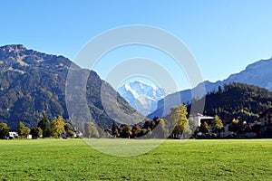 Interlaken, Switzerland, Immense lawn garden surrounded by giant mountains photo