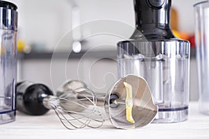 Immersion hand blender on table on a kitchen background, closeup