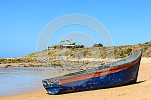 Immigrant dinghy boat stranded at the beach of Zahora, South Spain, near Africa. photo