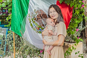 Immigrant family in front of the Mexican flag. New Mexicans. Childbirth in Mexico