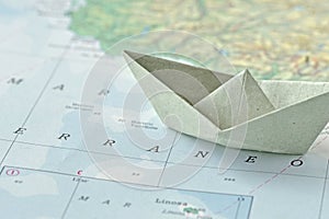 Immigration and ask for asylum concept - paper boat on map photo