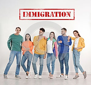 Immigration concept. Group of people standing near light wall