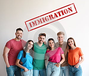 Immigration concept. Group of people standing near light wall