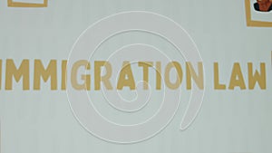 Immigration Law inscription on white background. Graphic presentation with drawn portraits of Afro-American people