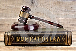 Immigration law. Judge gavel on the book on wooden table. justice and law concept. Employment law.