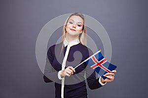 Immigration and the study of foreign languages, concept. A young smiling woman with a Iceland flag in her hand.