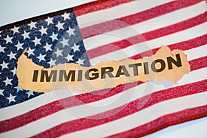 Immigration word laying on American Flag