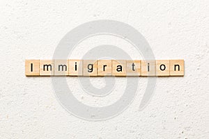 immigration word written on wood block. immigration text on table, concept