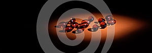 Immune prevention supplement red pills isometric view banner. toco-sorb supplement softgels selective focus photo in lowkey