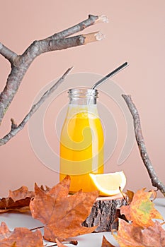 Immune system boosting drink or smoothie with ginger, lemon and turmeric on wooden stand for autumn or virus season on
