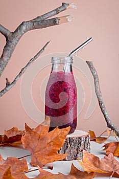 Immune system boosting red berries smoothie on wooden stand for autumn or virus season on neutral background with