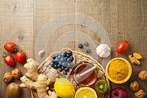 Immunity boosters fruits and vegetables on wooden table. Top view health care background with copy space