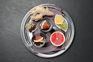 Immunity boosting drink and ingredients on black table, top view