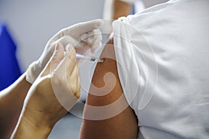 Immunization vaccine injection , doctor inject vaccine to patient arm