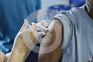 Immunization vaccine injection , doctor inject vaccine to patient arm