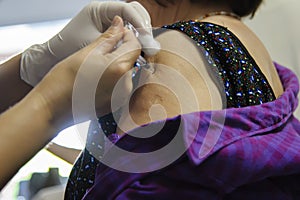 Immunization vaccine injection , doctor inject vaccine to patient arm photo