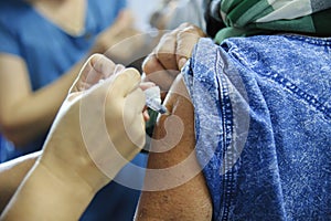 Immunization vaccine injection , doctor inject vaccine to patient arm