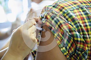 Immunization vaccine injection , doctor inject vaccine to patient arm photo