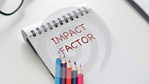 Impact Factor text on white an paper on white background.