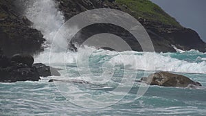 The impact of the waves on the cliffs or shoreline