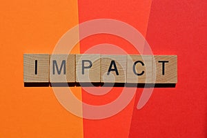 Impact, word in 3d wood letter blocks on red