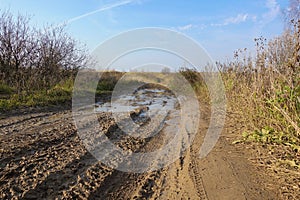 Impassable dirt road. Puddle and dirt on the road photo