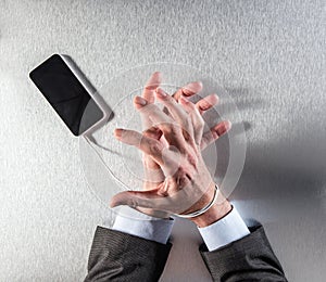 Impatient businessman hands obsessed with mobile slavery and technology dependence
