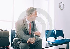 Impatient businessman waiting for a meeting photo