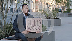 Impatient desperate hopeless young black student holding poster need work. Mixed race businessman entrepreneur bankrupt