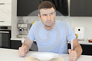 Impatient looking man waiting for dinner to be served