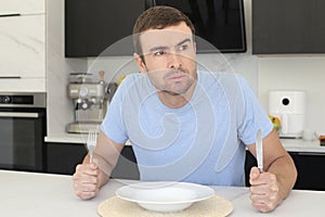 Impatient looking man waiting for dinner to be served