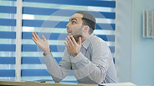 Impatient male patient waiting at the reception desk