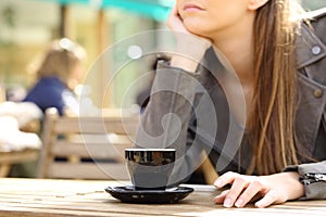 Impatient woman waiting on a cafe terrace