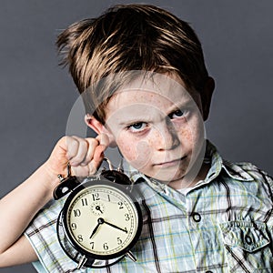 Impatient young boy with a dark look reproaching alarming deadlines