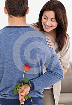 Impatiente woman looking at a flower hidden