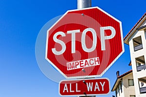 Impeach sticker applied on a Stop traffic sign; San Francisco bay area, California photo