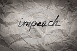 The impeach text word on crumpled paper - government and politics concept