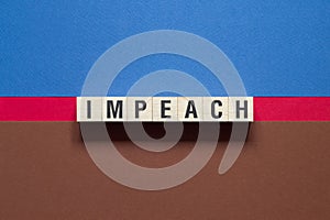Impeach word concept on cubes photo
