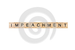 impeachment. English word on white isolated background composed from letters on wooden cubes. Learning english concept.
