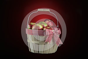Imperfect apples basket isolated on black and red