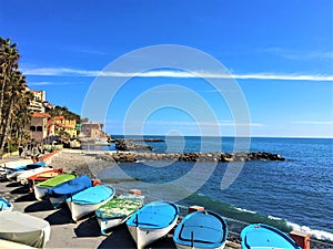 Imperia city, Liguria region, Italy. Sea, water, boats, rocks and sunny day