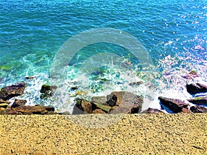 Imperia city, Liguria region, Italy. Sea, water, waves and rocks, nature and peace