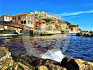 Imperia city, Liguria region, Italy. Sea, waves, bridge, rocks and touristic attraction