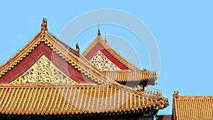 The Imperial Palace in Beijing Forbidden City. curved roofs with gold patterns in traditional Chinese style with ceramic figures