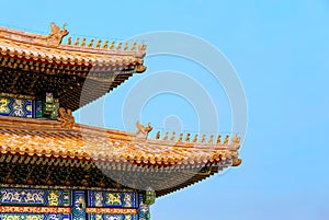 The Imperial Palace in Beijing Forbidden City. curved roofs in traditional Chinese style with figures on the blue sky background