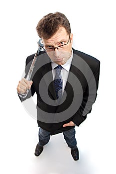 Impertinent businessman with steel wrench photo