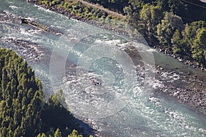 Impetuous river with blue water and many trees