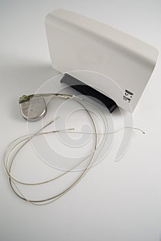 An Implantable Cardioverter Defibrillator or ICD pacemaker with leads and modem for telemonitoring at home. The device sends data