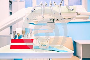 Implantology. Dental implants in dental clinic with human jaw model photo